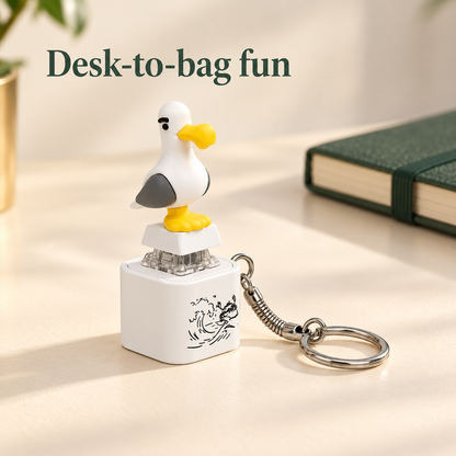 Single seagull keychain on an ivory desk with the message Desk-to-bag fun